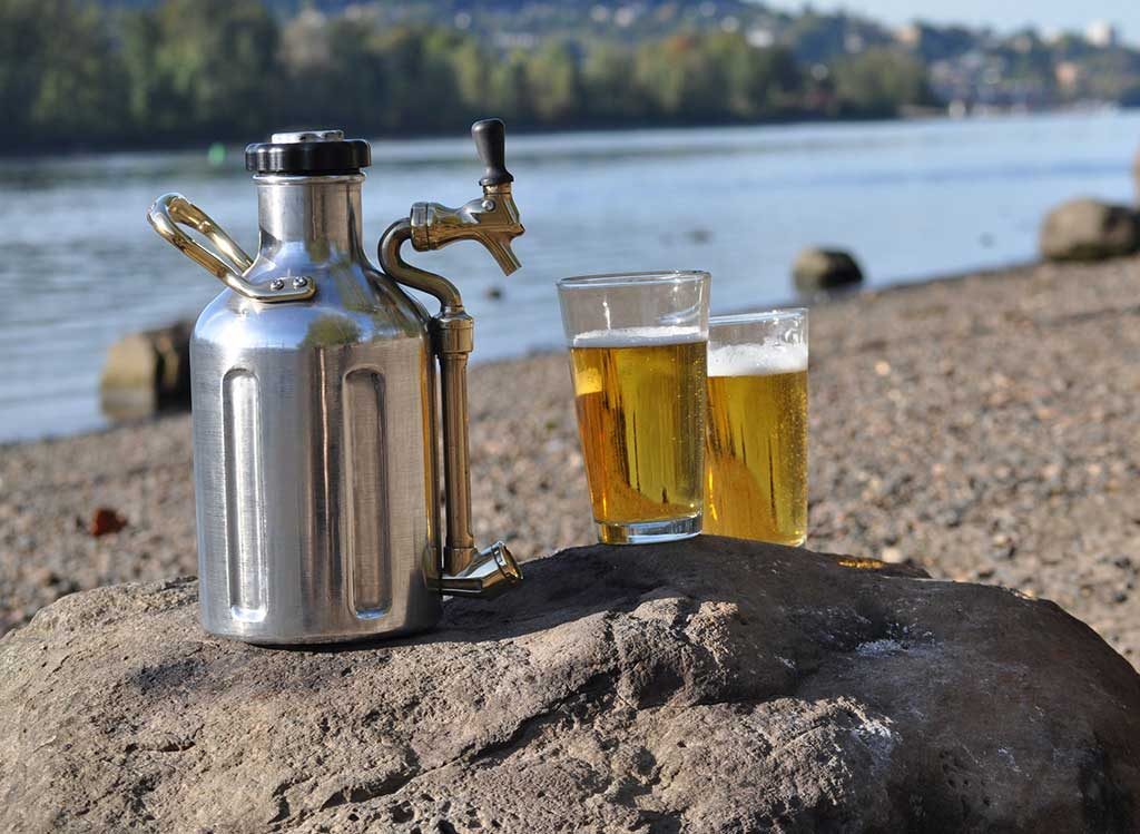 Stainless Steel uKeg on a beach with 2 pints
